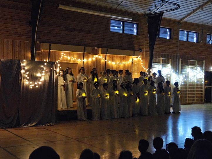 en gruppe mennesker i hvite kapper og en gruppe mennesker i et rom med en scene og